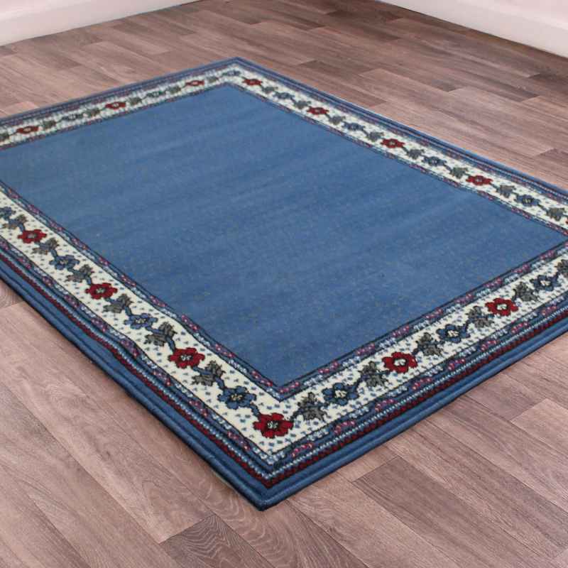 Valencia Plain Bordered Rugs in Blue
